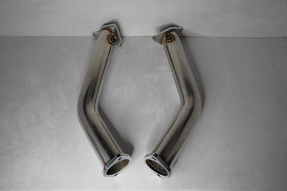Two chrome exhaust pipes on a gray background